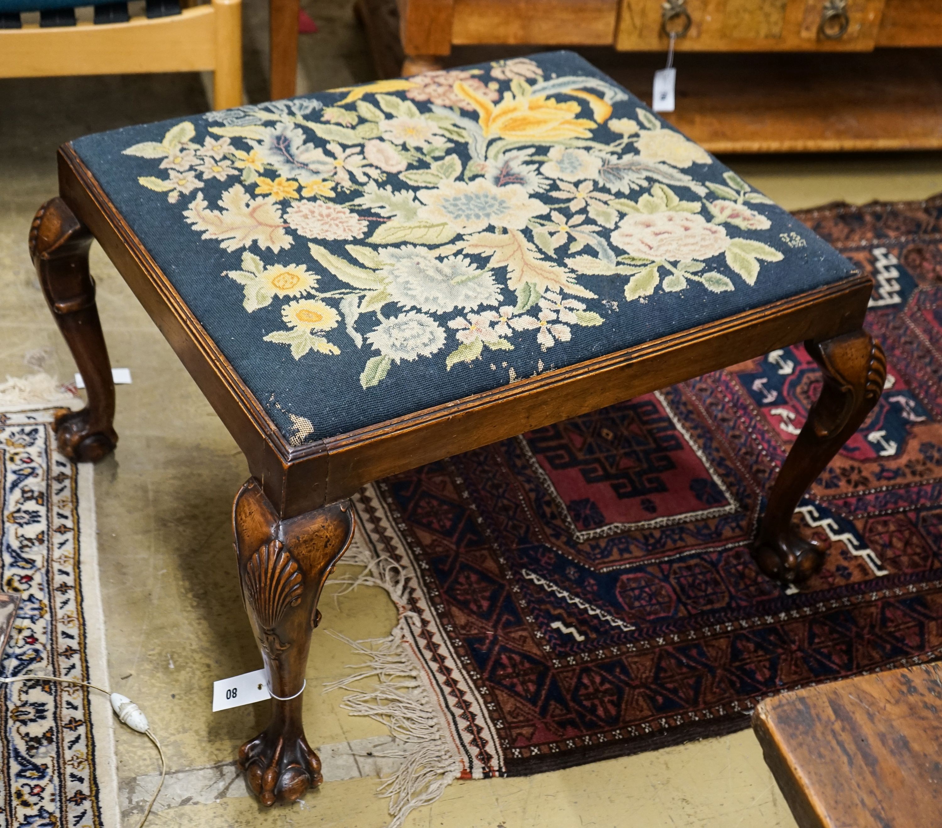 A George III style mahogany stool with drop in tapestry seat on ball and claw feet, signed JS 1927, length 76cm, depth 66cm, height 46cm